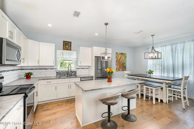 a kitchen with lots of counter top space and dining table