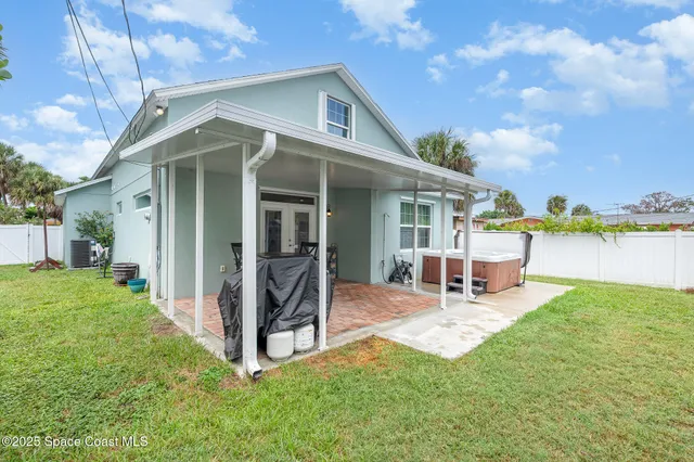a view of a house with backyard porch and sitting area