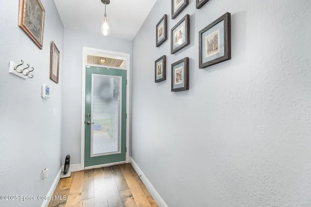 a view of an entryway with wooden floor