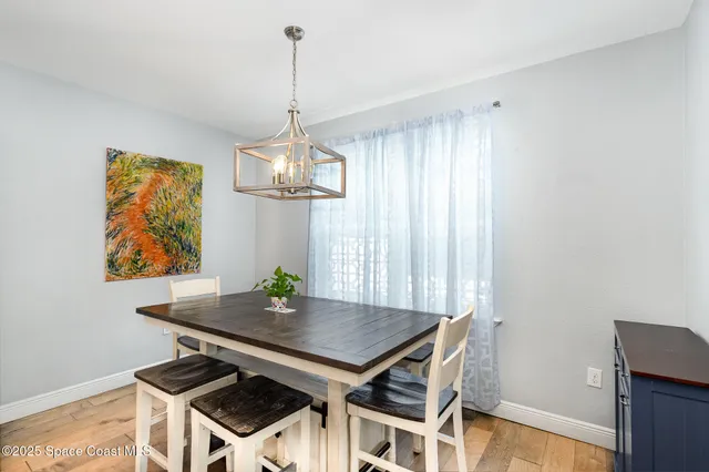 a view of a workspace with furniture and a chandelier