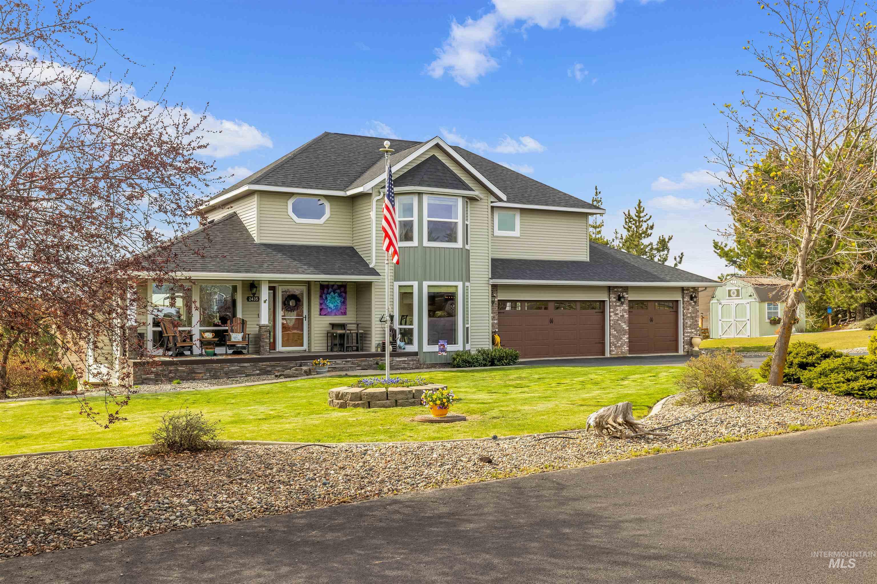 2435 Arborcrest Road Moscow, ID 83843 - Photo 5 of 50 View of front facade featuring roof with shingles, a front lawn, driveway, and covered porch
