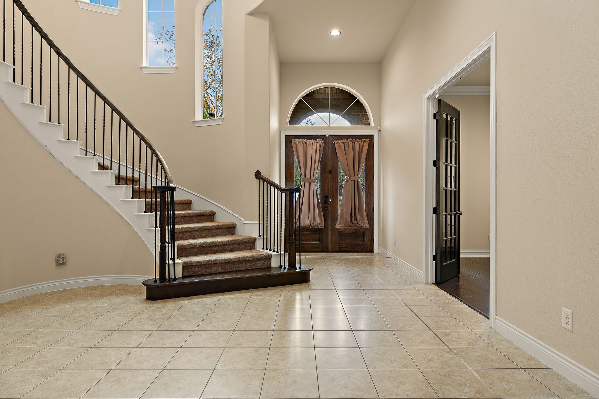 174 Estrella Crossing Georgetown, TX 78628 - Photo 4 of 38 Foyer with light tile patterned flooring, stairs, a towering ceiling, and recessed lighting