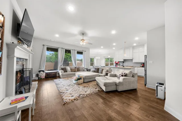a living room with fireplace furniture and a flat screen tv