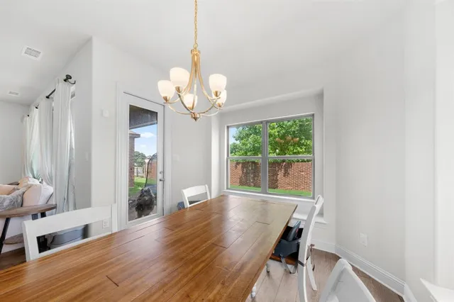 a view of a livingroom with wooden floor and a large window