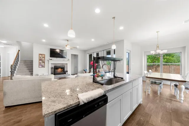 a kitchen with sink refrigerator and microwave