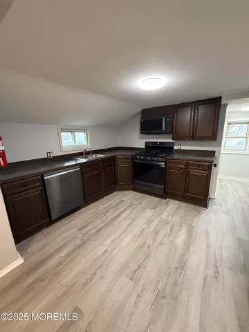 a kitchen with stainless steel appliances granite countertop a stove and a sink