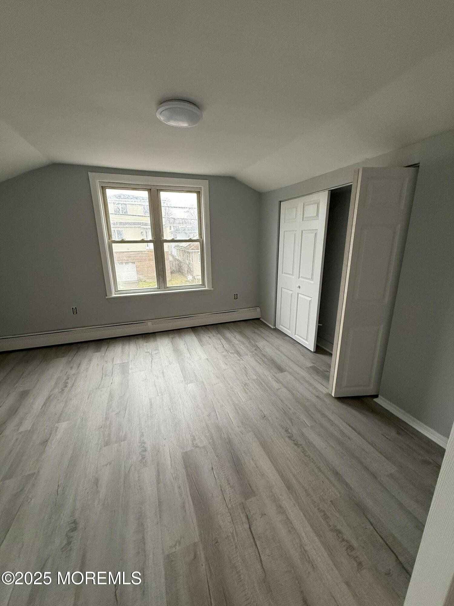 79 Pine View Avenue Keansburg, NJ 07734 - Photo 20 of 20 an empty room with wooden floor and windows