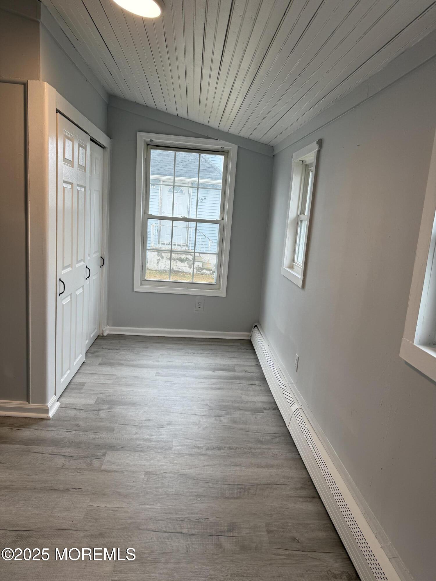 79 Pine View Avenue Keansburg, NJ 07734 - Photo 4 of 20 a view of an empty room with a window and wooden floor