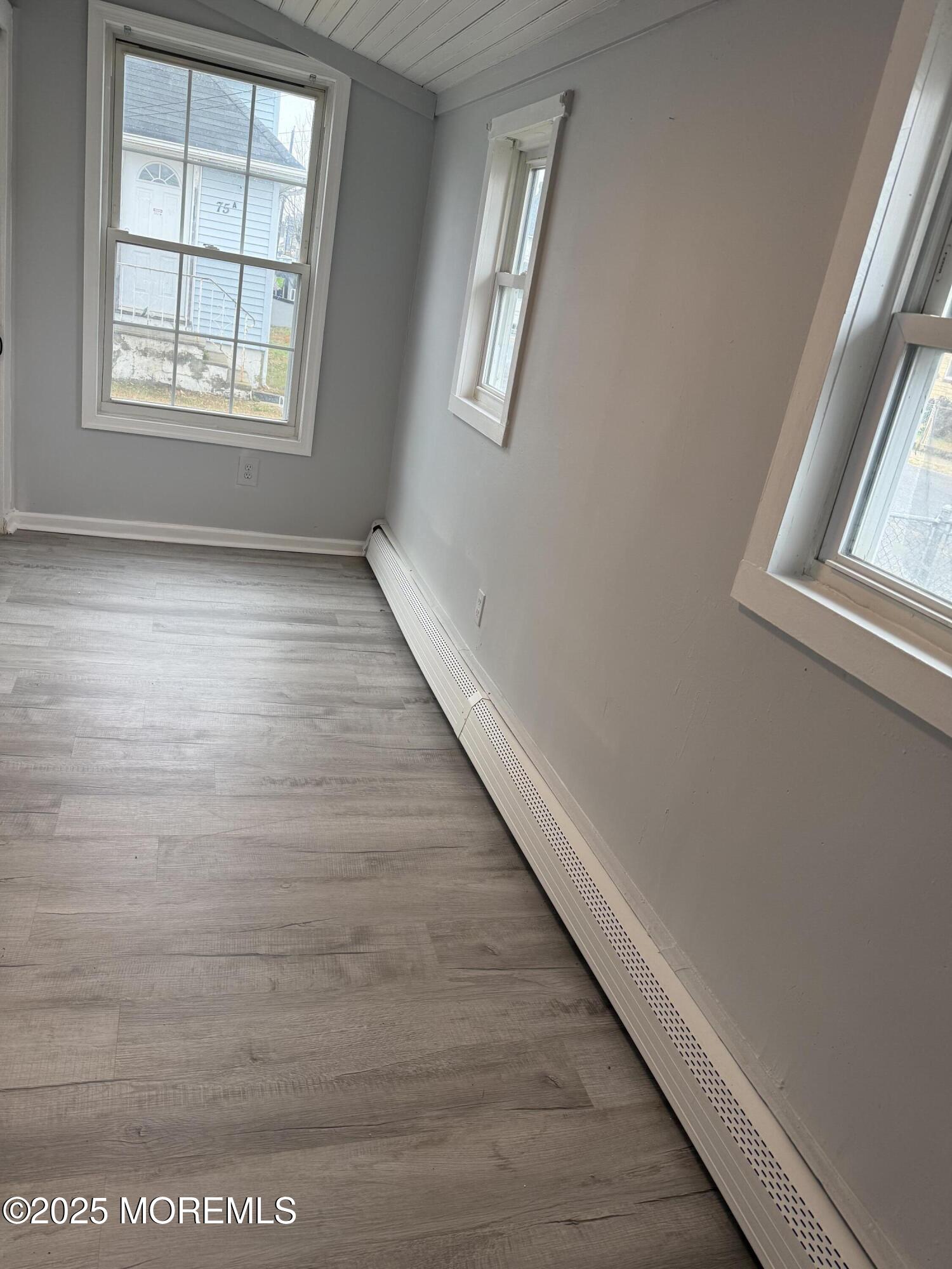 79 Pine View Avenue Keansburg, NJ 07734 - Photo 5 of 20 a view of an empty room with wooden floor and a window