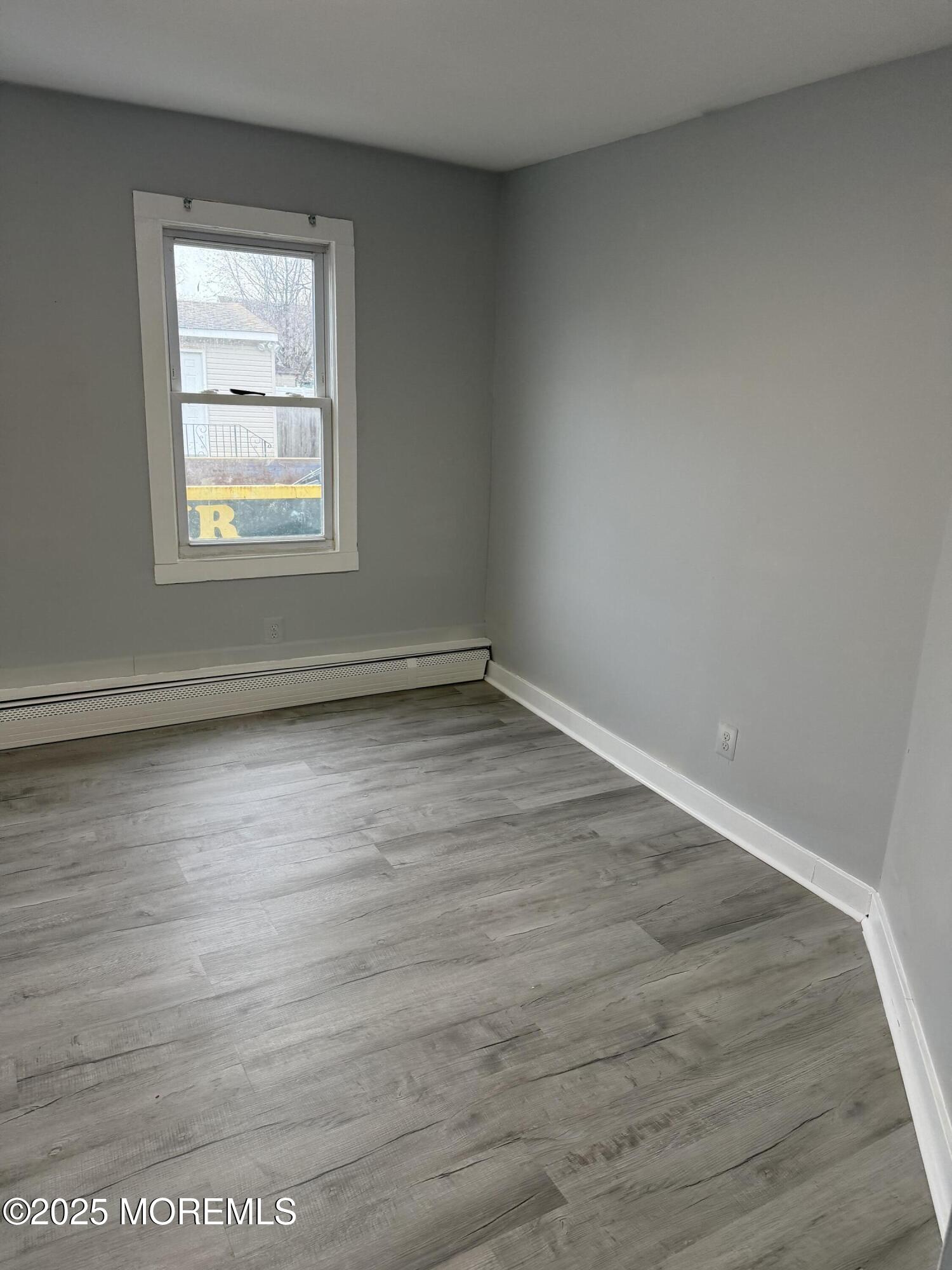 79 Pine View Avenue Keansburg, NJ 07734 - Photo 9 of 20 a view of an empty room with wooden floor and a window