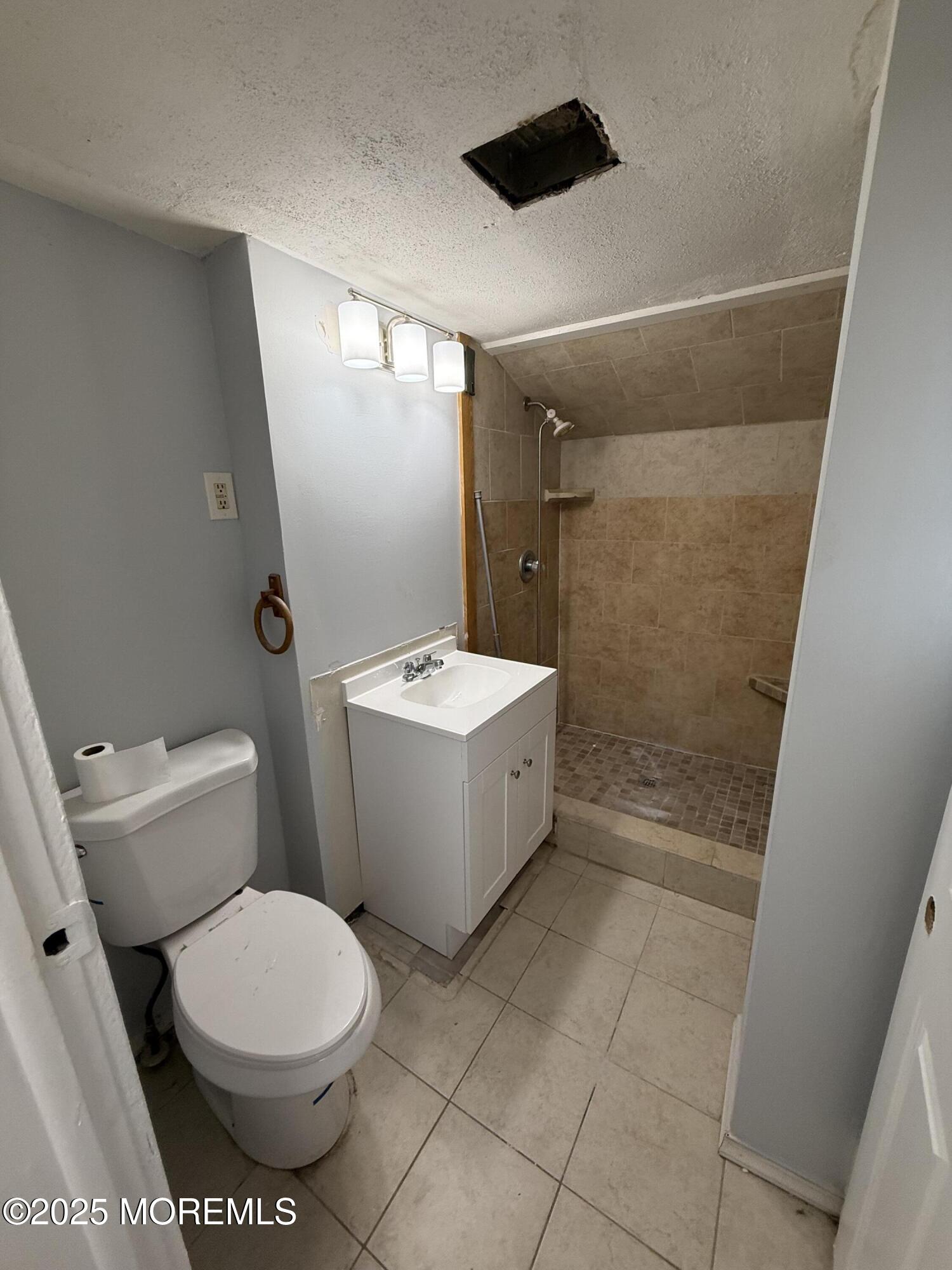 79 Pine View Avenue Keansburg, NJ 07734 - Photo 10 of 20 a bathroom with a sink a toilet a mirror and bathtub