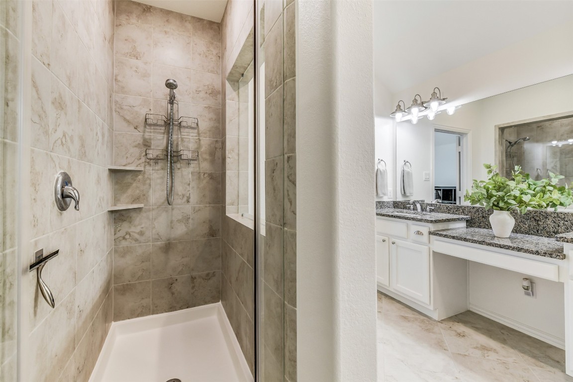 29519 Crimson Beech Drive Spring, TX 77386 - Photo 13 of 22 This primary bathroom features a oversized sleek glass-enclosed shower with elegant tile work. Ad