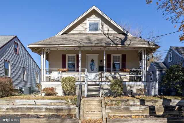 a view of a white house with large windows