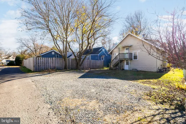 a front view of a house with a yard covered in snow