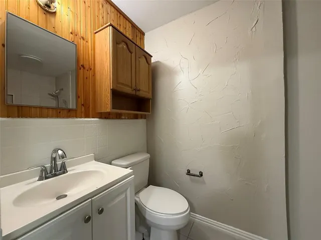 a bathroom with a sink a toilet and mirror