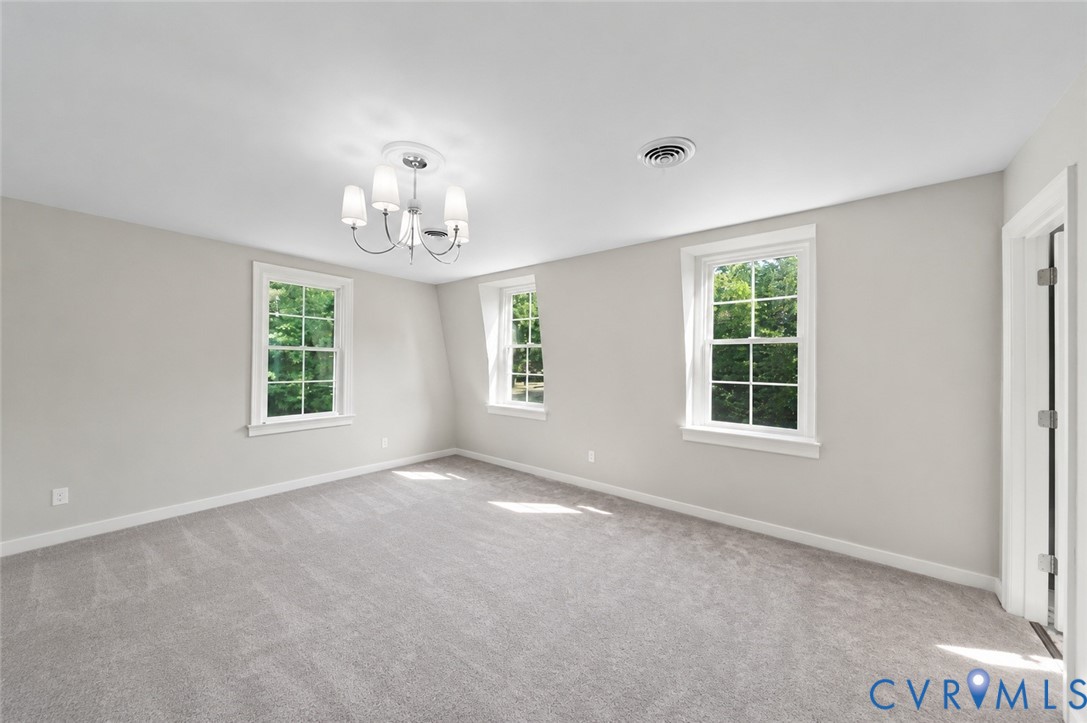 20010 River Road Chesterfield, VA 23838 - Photo 19 of 36 an empty room with windows and chandelier fan