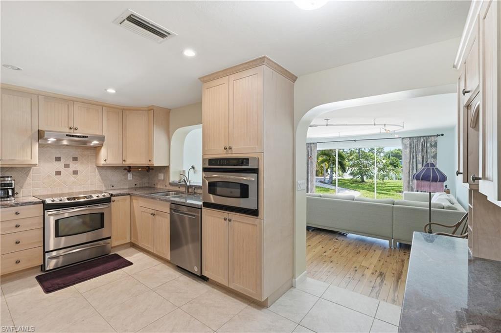 1316 Rordon Avenue Naples, FL 34103 - Photo 11 of 38 Kitchen featuring light wood cabinetry, stainless steel appliances, and tile flooring