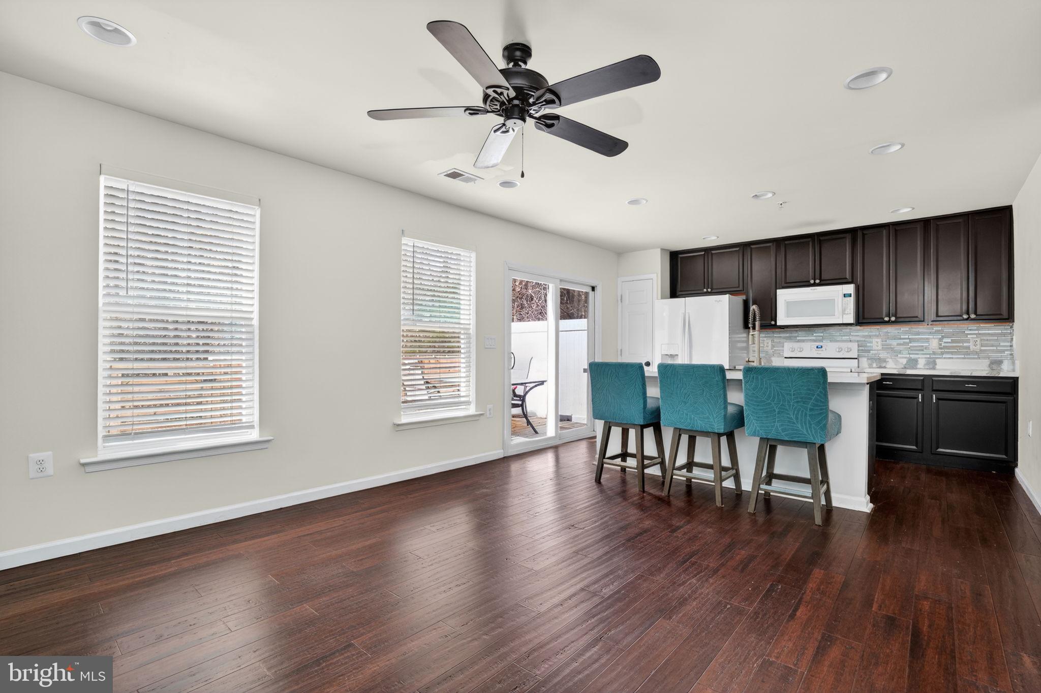 158 Intrepid Lane, Unit 92 Berlin, MD 21811 - Photo 14 of 37 a living room with stainless steel appliances granite countertop furniture wooden floor and a window