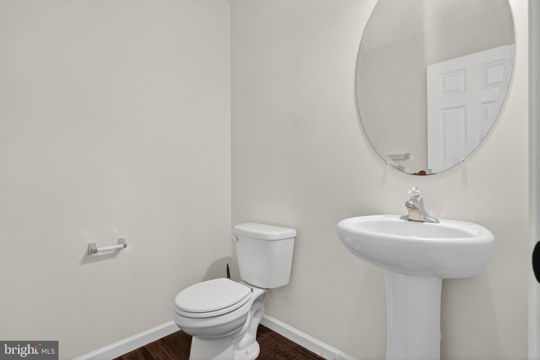 158 Intrepid Lane, Unit 92 Berlin, MD 21811 - Photo 17 of 37 a bathroom with a toilet sink and mirror