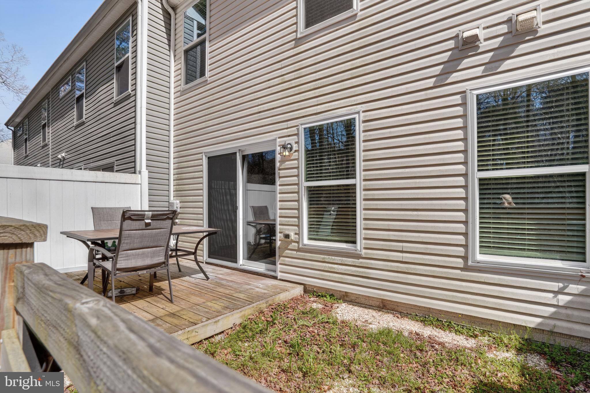 158 Intrepid Lane, Unit 92 Berlin, MD 21811 - Photo 34 of 37 a wooden bench sitting in front of a house