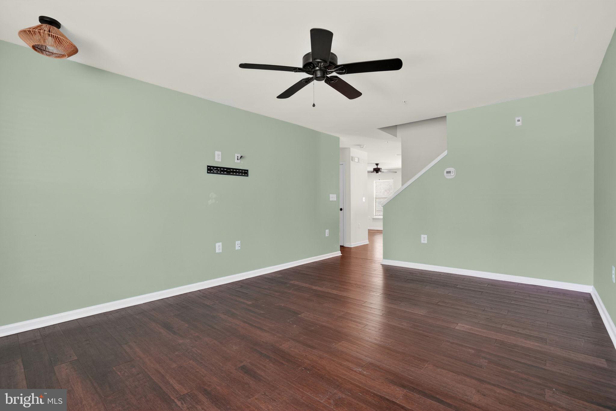158 Intrepid Lane, Unit 92 Berlin, MD 21811 - Photo 4 of 37 a view of a room with wooden floor and a ceiling fan