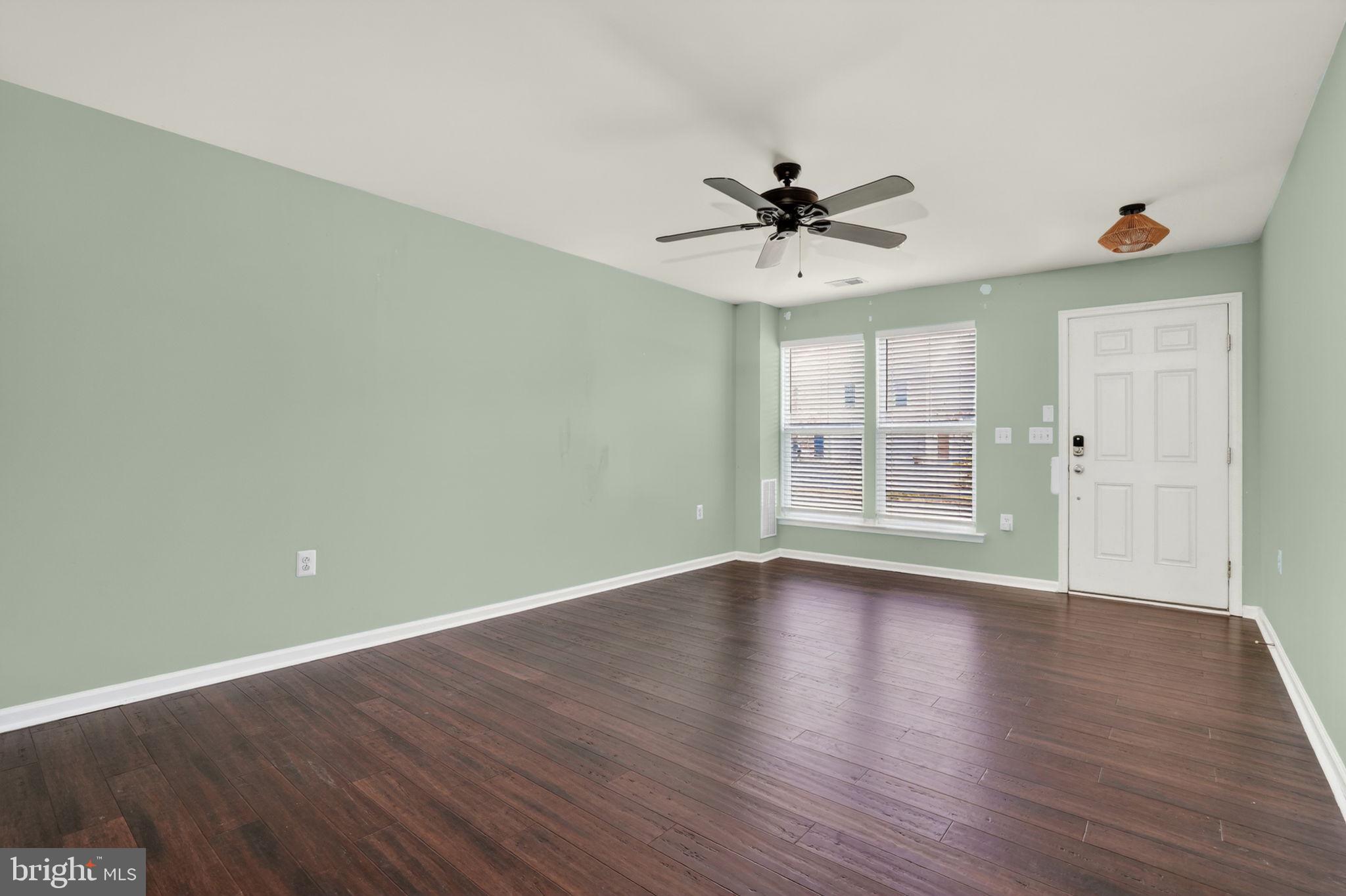 158 Intrepid Lane, Unit 92 Berlin, MD 21811 - Photo 5 of 37 a view of an empty room with wooden floor and a window