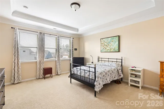 a bedroom with furniture and a large window