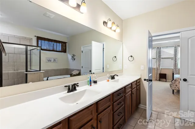 a bathroom with a double vanity sink mirror and double