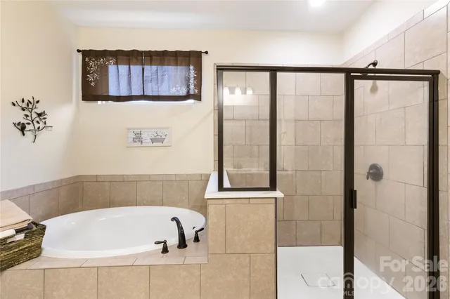 a bathroom with a bathtub and shower