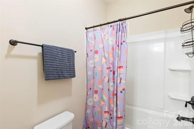 a bathroom with a shower curtain and a curtain