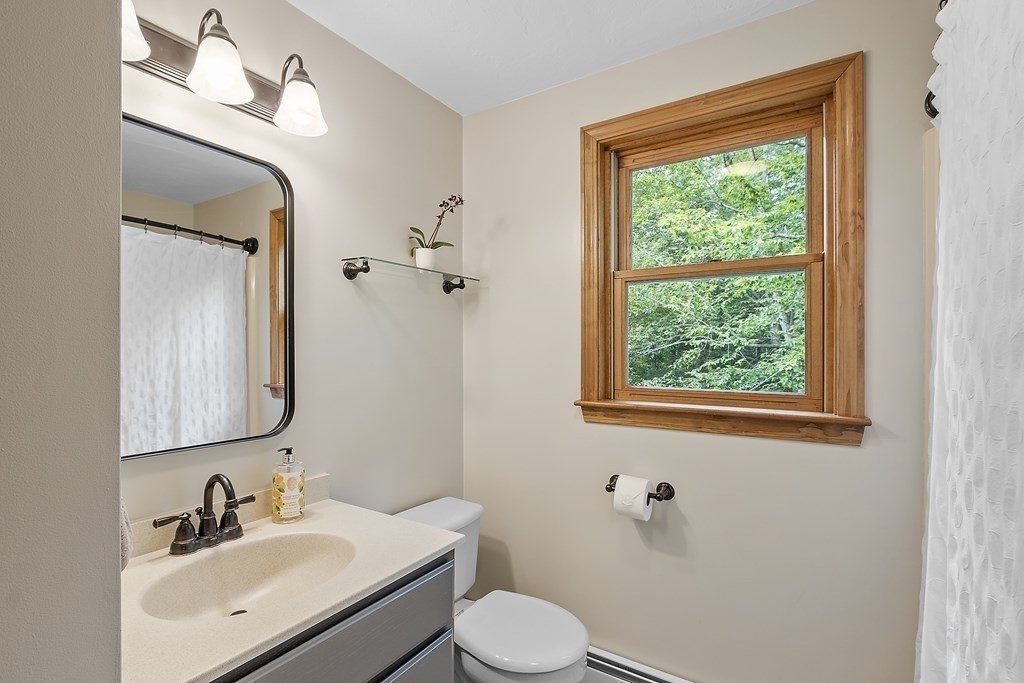 64 Wilder Road Ashby, MA 01431 - Photo 18 of 42 a bathroom with a toilet sink vanity and mirror