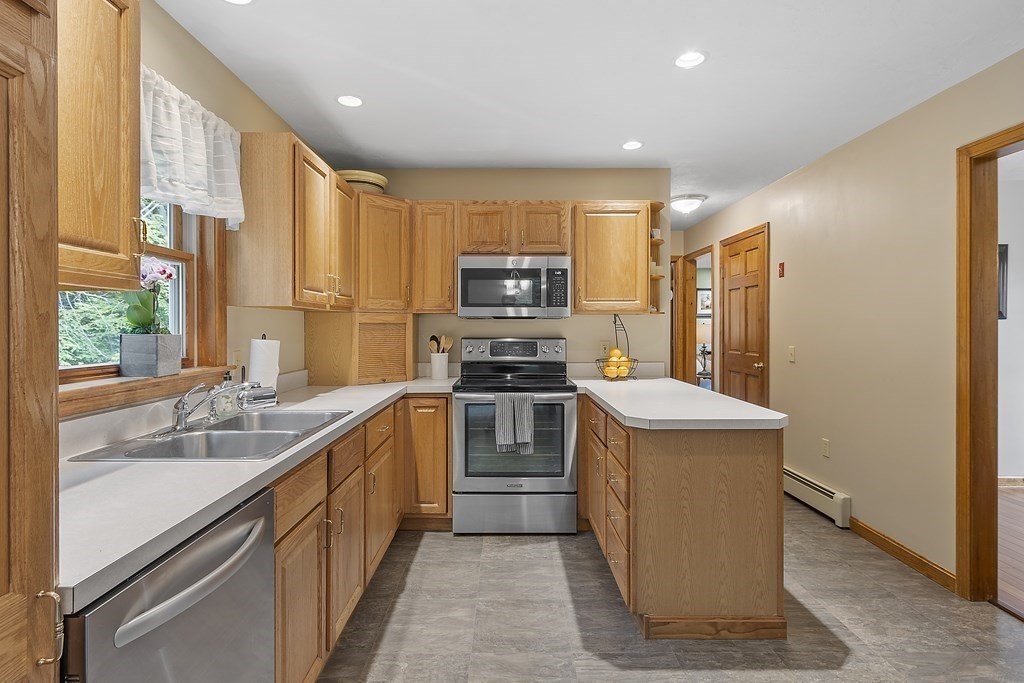 64 Wilder Road Ashby, MA 01431 - Photo 23 of 42 a kitchen with stainless steel appliances granite countertop a stove a sink and a refrigerator
