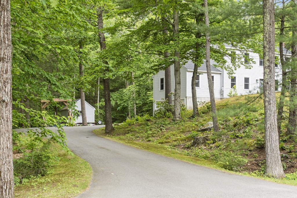 64 Wilder Road Ashby, MA 01431 - Photo 3 of 42 a view of a yard in front of a house with large tree