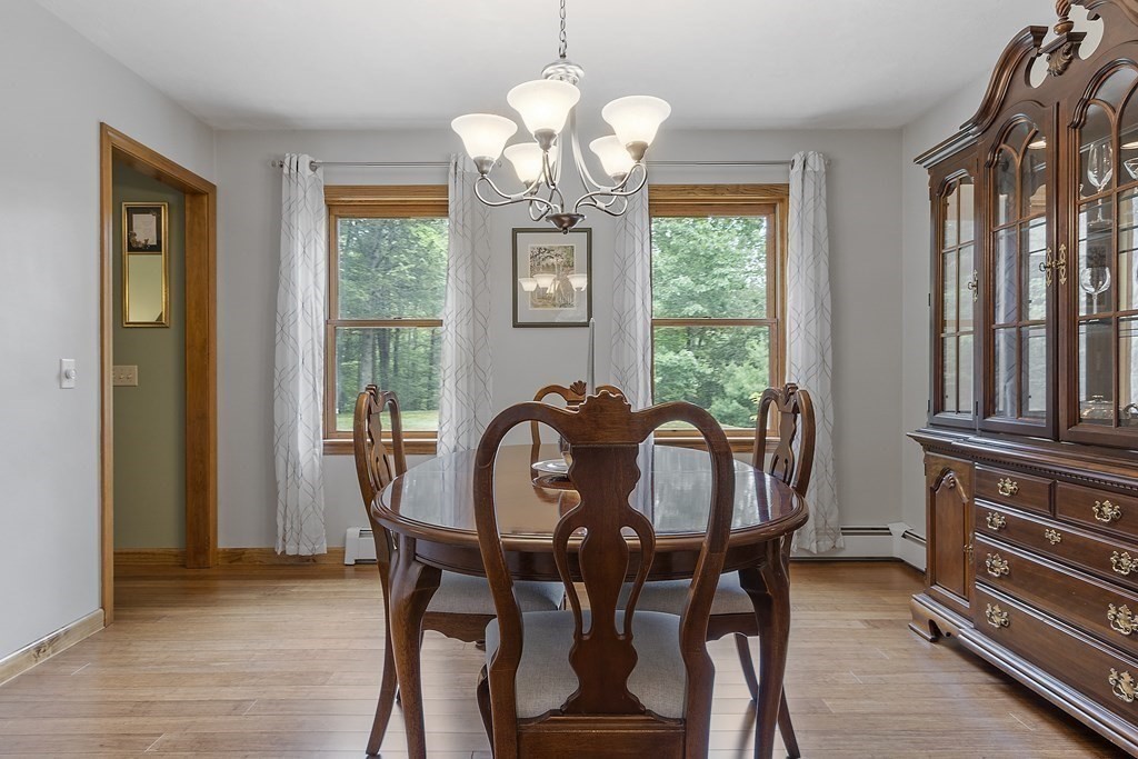 64 Wilder Road Ashby, MA 01431 - Photo 33 of 42 a dining room with furniture a chandelier and wooden floor