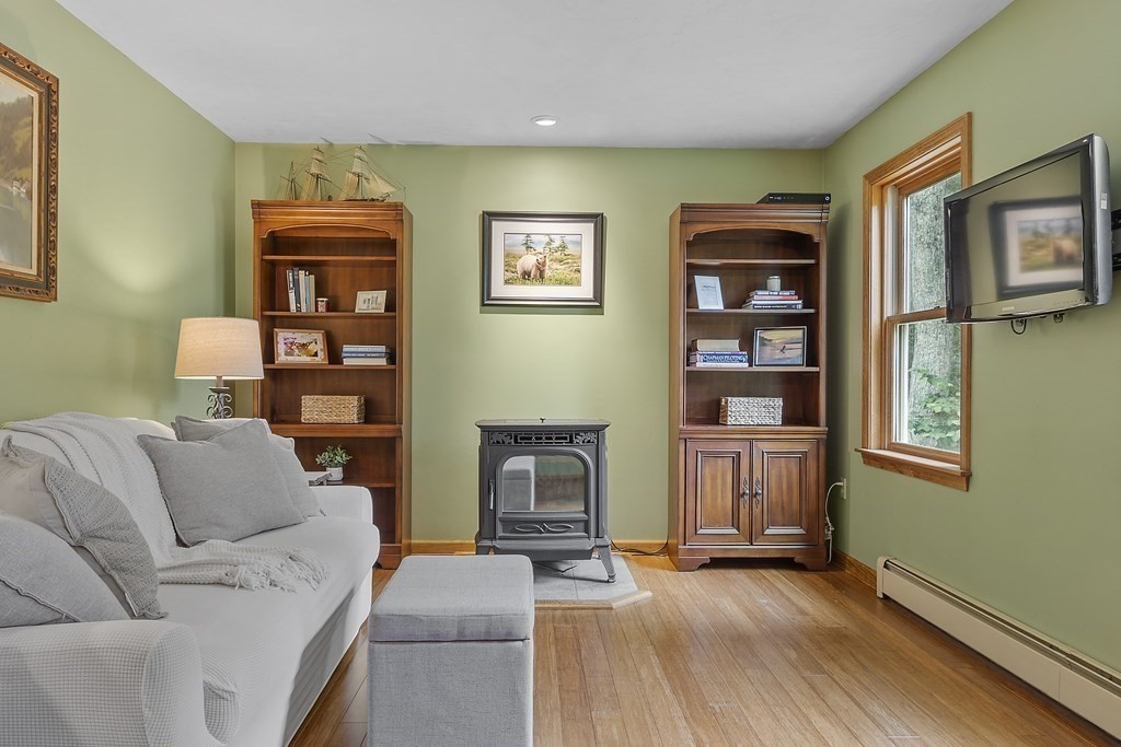 64 Wilder Road Ashby, MA 01431 - Photo 35 of 42 a living room with furniture and a fireplace