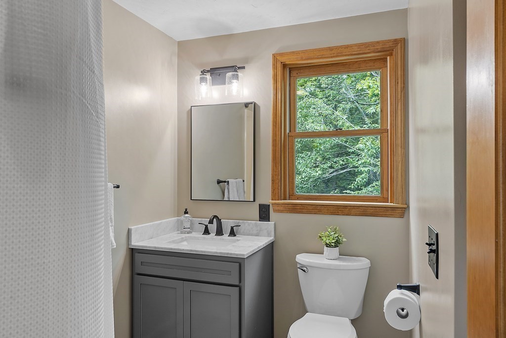 64 Wilder Road Ashby, MA 01431 - Photo 10 of 42 a bathroom with a toilet sink and mirror