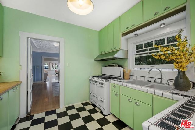 a kitchen with a sink and a stove top oven