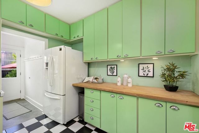 a kitchen with a refrigerator and cabinets
