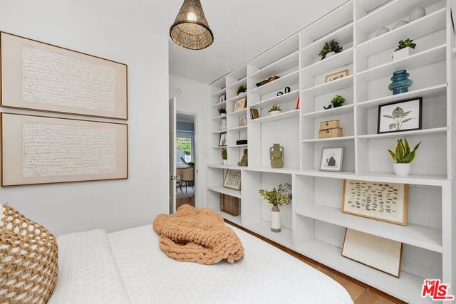 a bedroom with a bed and a book shelf