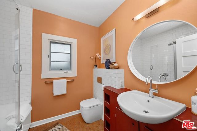 a bathroom with a sink a mirror and a toilet