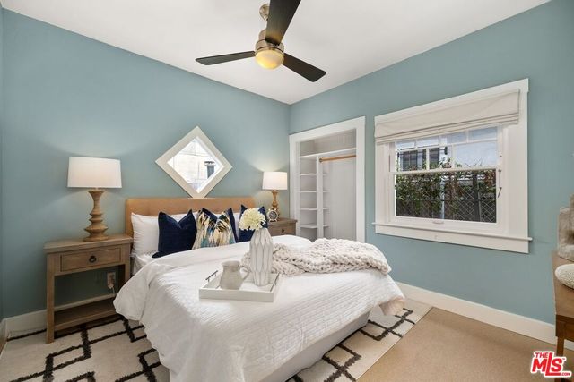 a bed room with a bed and a night stand