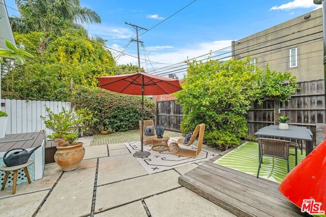 a view of a backyard with sitting area and furniture