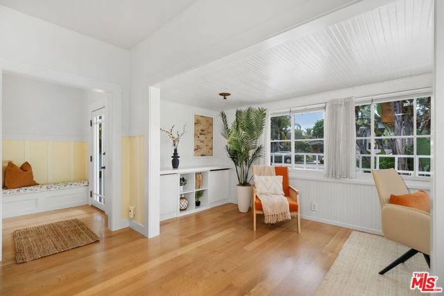 a living room with furniture and large windows