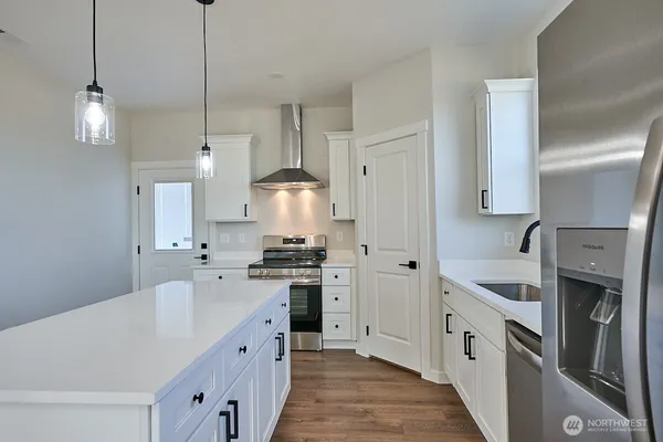 a kitchen with cabinets stove and a sink