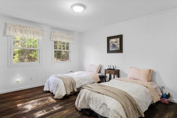 a bedroom with a bed a couch and a window