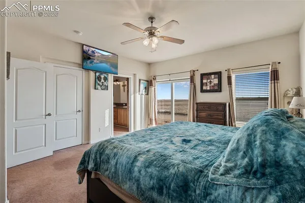 a bedroom with a large bed and a chandelier