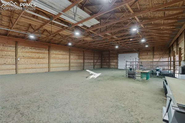 a view of empty room with wooden ceiling