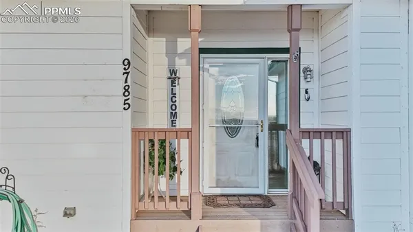 a view of a wooden door with a glass door