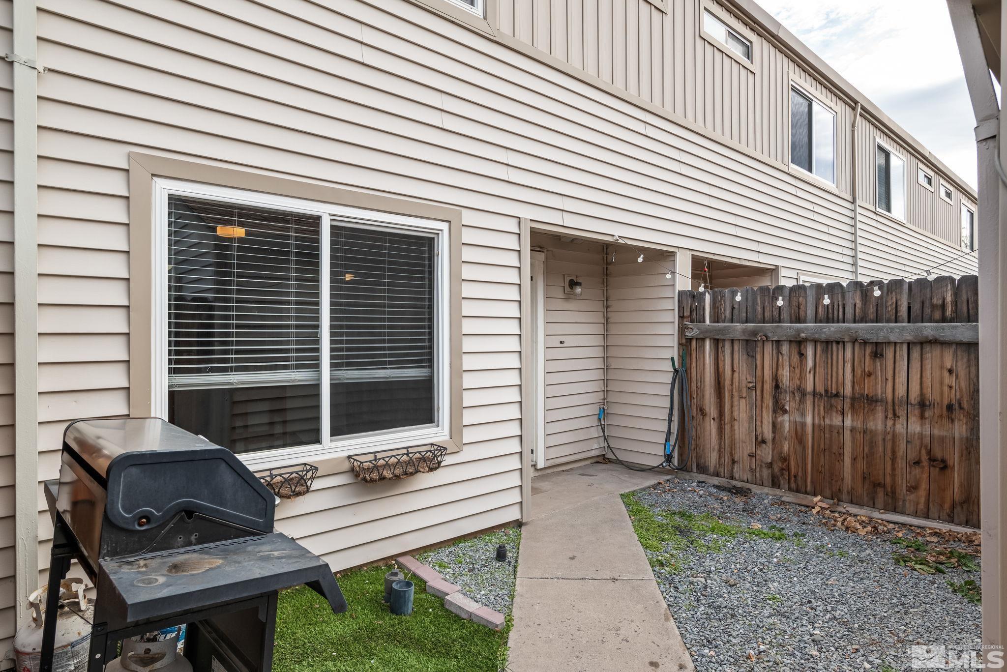 a house view with a backyard and a chair