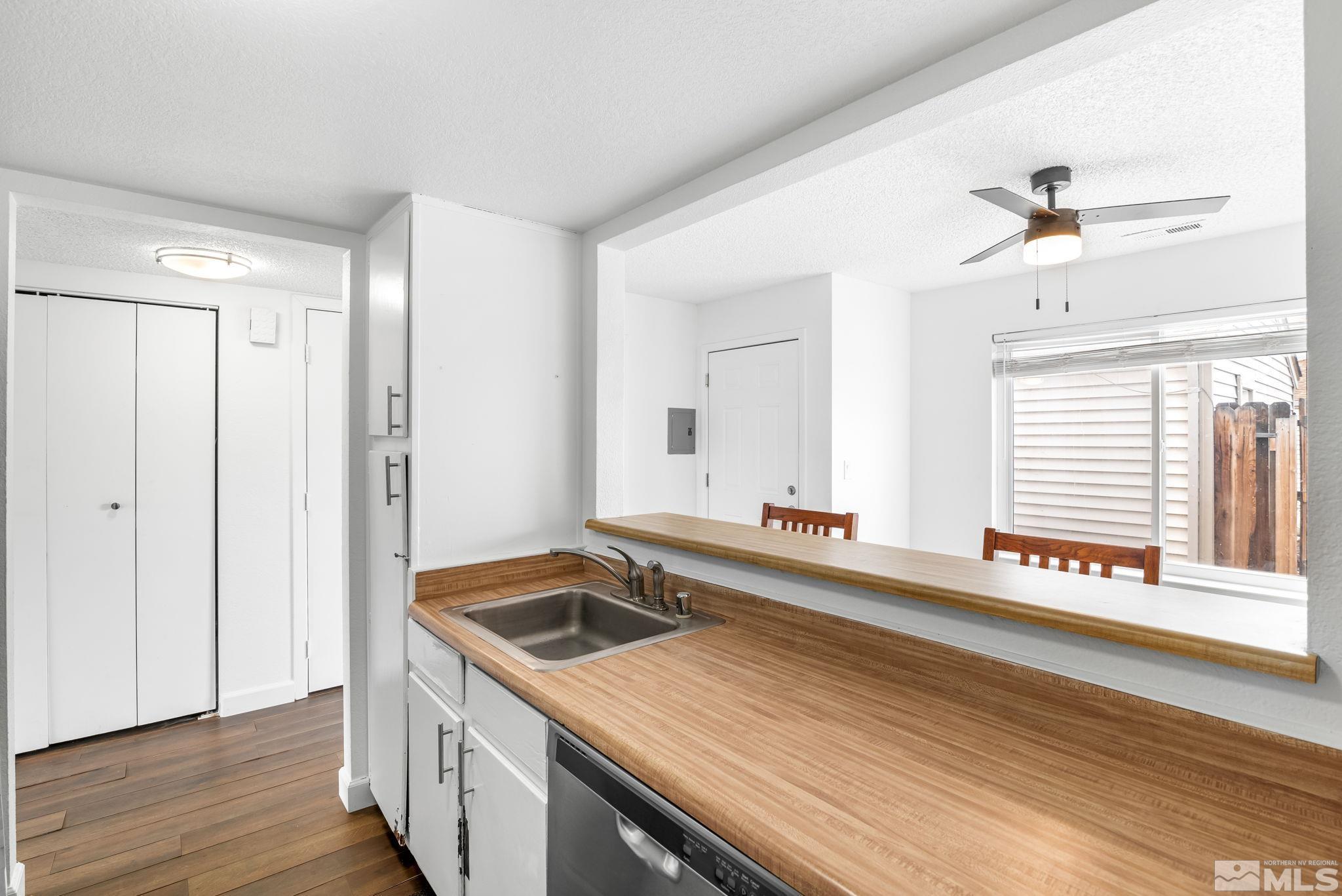 13968 Lear Boulevard Reno, NV 89506 - Photo 11 of 39 a kitchen that has a sink and a stove in it